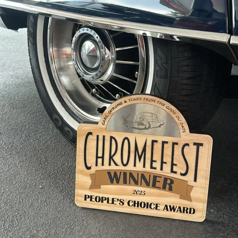 Chromefest 2025 People’s Choice Award winner plaque beside a classic wheel