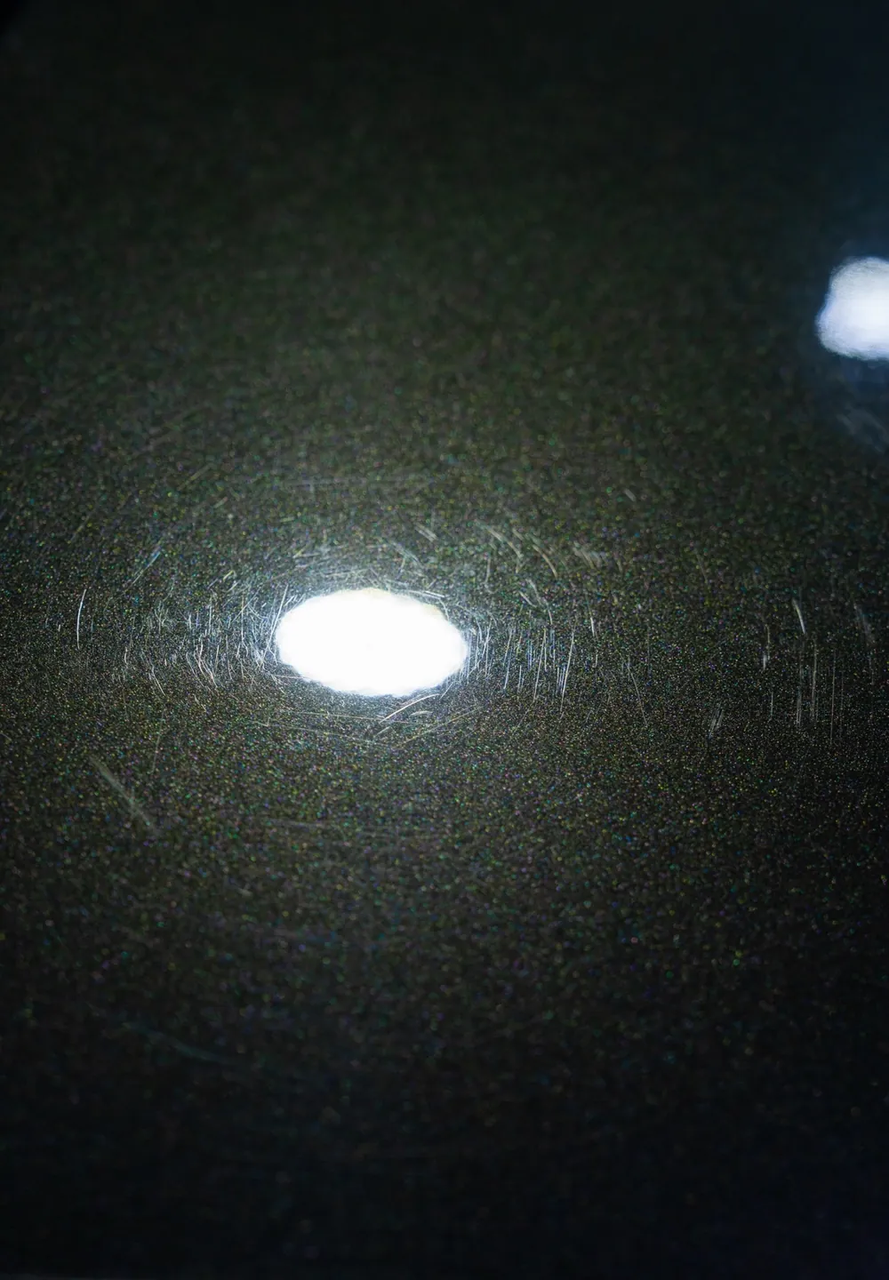 Paint under a light before correction, covered in swirl marks