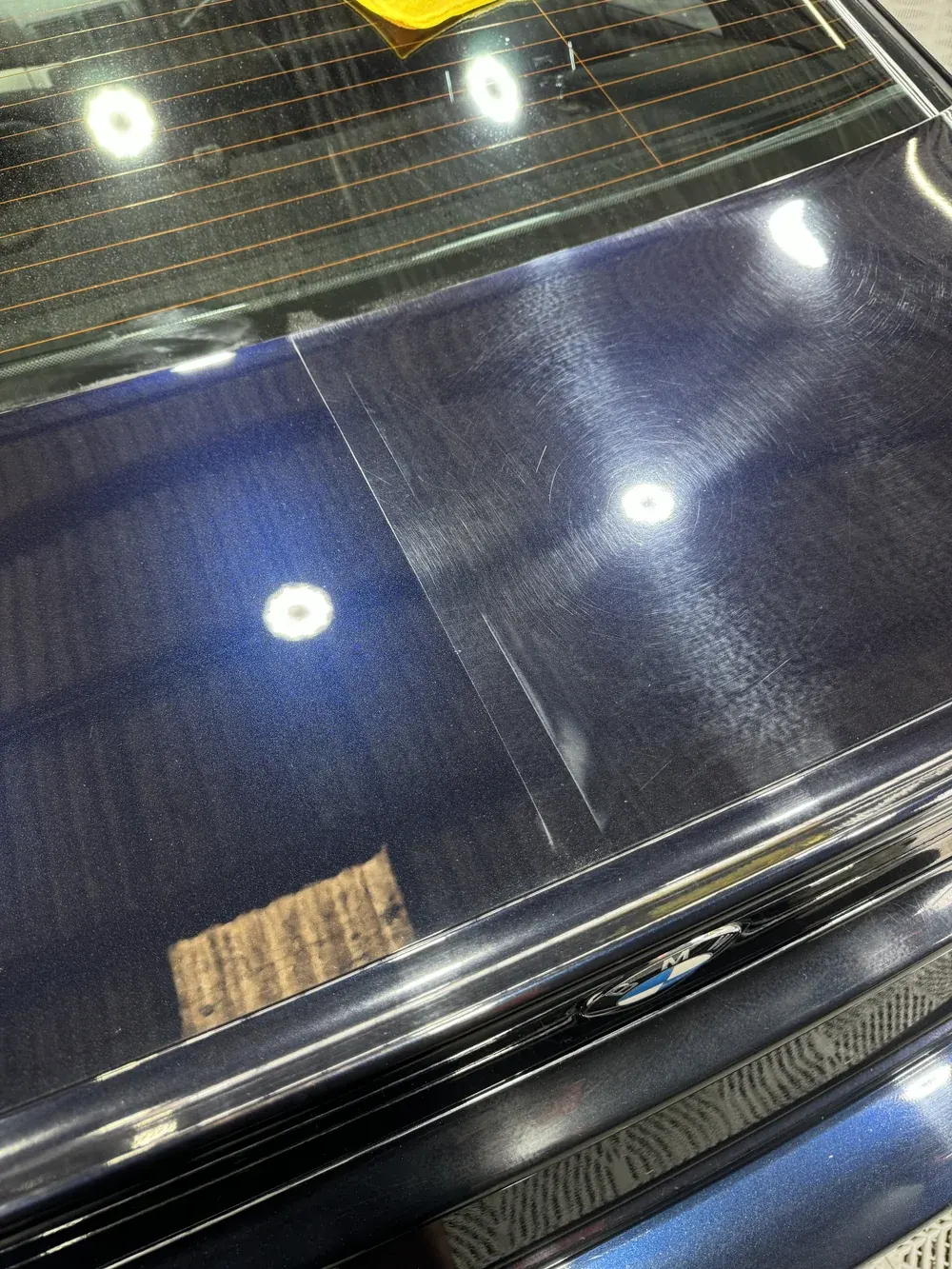Studio lights reflected in corrected dark blue paint