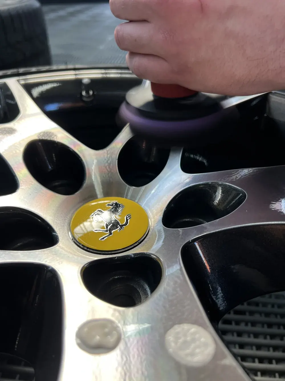 Polishing a Ferrari wheel by hand